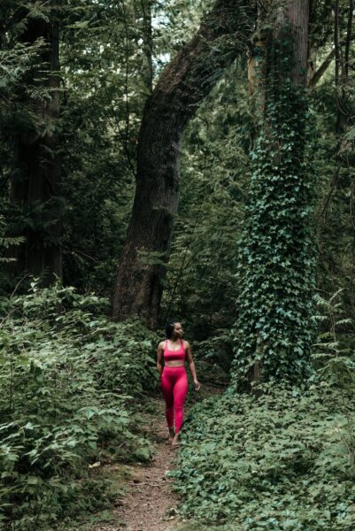 a woman walking in a forest
